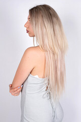 Fototapeta premium Young european woman with white skin isolated on grey with blonde hair