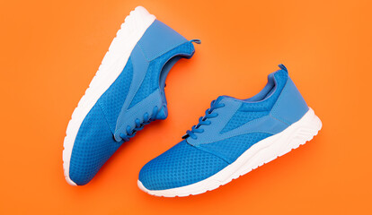 pair of footwear for training on orange background, fitness