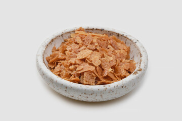 Heap of wafer or waffle crumb in a bowl on a white background.
