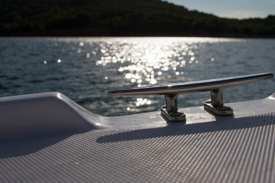 Steel mooring cleat on the small plastic pleasure boat, nautical equipment, Adriatic sea, Croatia