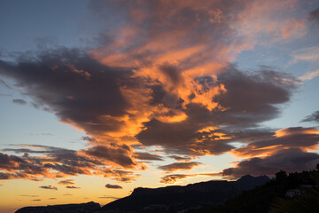 beautiful orange golden clouds at sunset on the mediterranean coast scenic sky background
