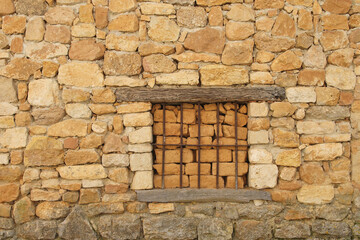 Window blinded with mud bricks in an abandoned house in Colmenares de Ojeda, north of Palencia province, Spain	