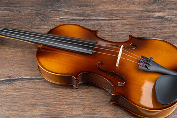 Part of the violin on a wooden background.