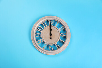 Stylish wall clock on turquoise background, top view