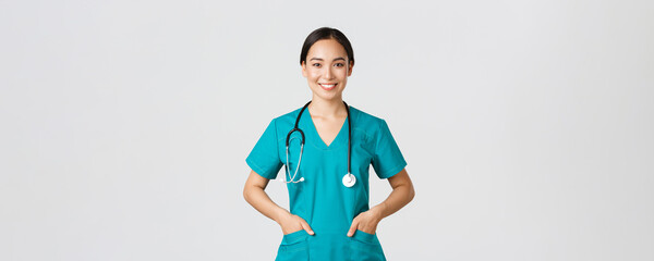 Covid-19, healthcare workers, pandemic concept. Confident smiling pretty asian female doctor,...