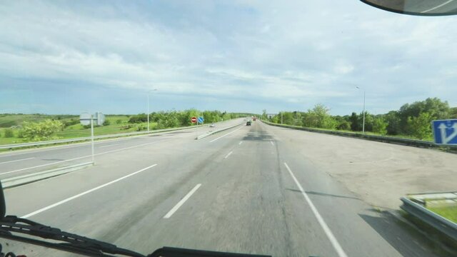 View of the road from the cab of the truck. View of the highway from the cab of the truck