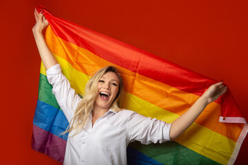 cheerful caucasian woman with lgbt flag 