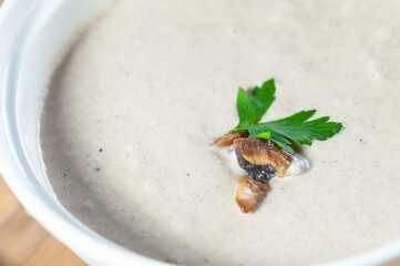 mushroom cream soup on a wooden background with mushrooms and spices macro photo
