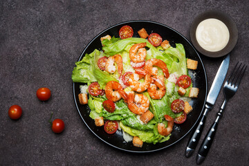 Caesar salad with shrimp, croutons and parmesan, top view