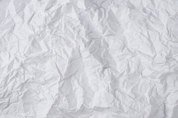 Crumpled white paper background.