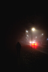 Fototapeta premium Man alone in the middle of the foggy street