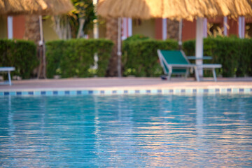 Blue clear water with small ripple waves in swimming pool at tropical resort. Summer vacations concept