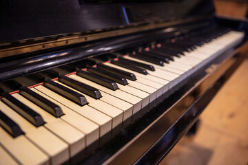 Fototapeta na wymiar Piano keys on old wooden musical instrument. Piano keyboard closeup view