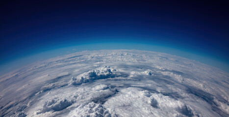 Fototapeta Planet Earth Curvature. Aerial shot. Blue sky and heavy clouds obraz
