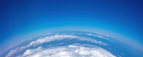 Curvature of planet earth. Aerial shot. Blue sky and clouds