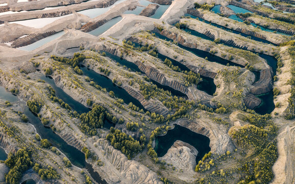 Aerial view of the landscape after gold mining by a special gold washing machine in an industrial quarry in Siberia, Magadan region, Russia.