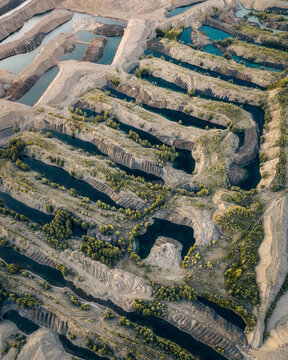 Aerial view of the landscape after gold mining by a special gold washing machine in an industrial quarry in Siberia, Magadan region, Russia.