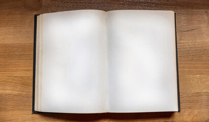 Open notebook on wooden background, top view. Blank book page on a table. Copy space, template