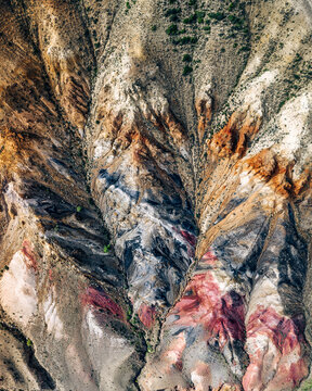 Aerial view of multicoloured textures of clay rocks coming to the surface of the ground in place that named Altaian Mars, Kosh-Agach, Altai Republic, Russia.