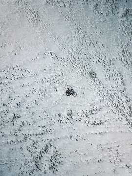 Aerial view of bicycle on frozen lake in Joniskis, Lithuania.