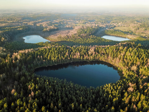 Aerial view of tiny forest lakes in Kurtuvenai regional park in Lithuania.