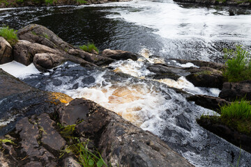 Waterfalls of Ruskeala, water with foam goes over rocks