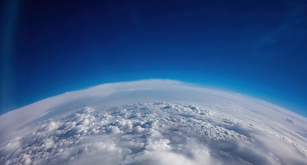 Planet Earth Curvature. Aerial shot. Blue sky and heavy clouds