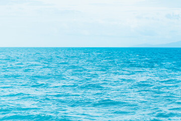 Fototapeta na wymiar Bright Blue ocean with smooth wave background.