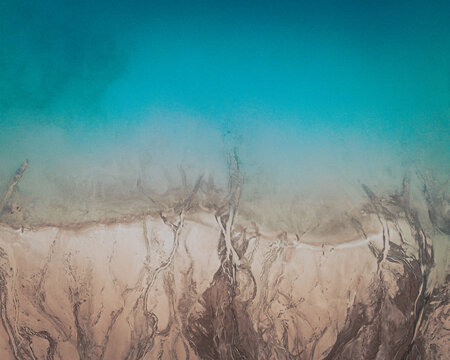 Aerial view of an abstract blue and turquoise clay lake, Art-sur-Meurthe, France.