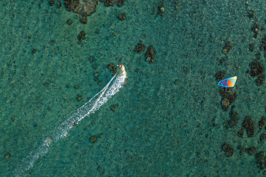 Aerial view of a person doing kite surfing along the coast at Plage de la Saline beach, Reunion.