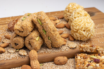 Indian traditional sweets Mithai Gajjak Also Known As Gur Gajja Gazak Gachak Made Of Jaggery Gud til or sesame seed Almonds Badam And Pistachio prepared during for Makar Sankranti Lohri