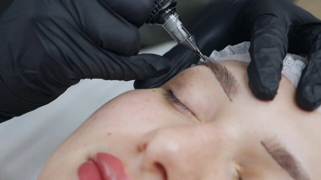 Microblading procedure. Master works with the eyebrows
