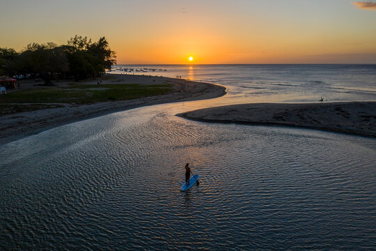 Aerial view of a person paddling with a board at Riviere du Rempart, a river near Baie du Tamarin, a beautiful bay in Mauritius.