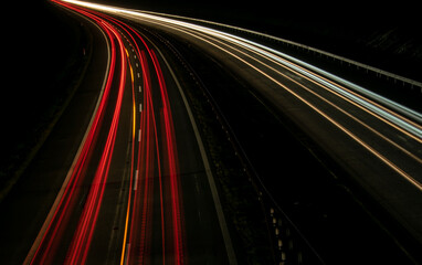 Night road lights. Lights of moving cars at night. long exposure red, blue, green, orange.