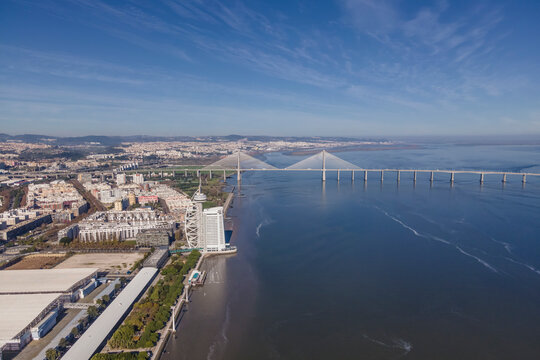 Aerial view of Oriente district from above, view of Vasco da Gama bridge crossing the Tagus river in Lisbon, Portugal.