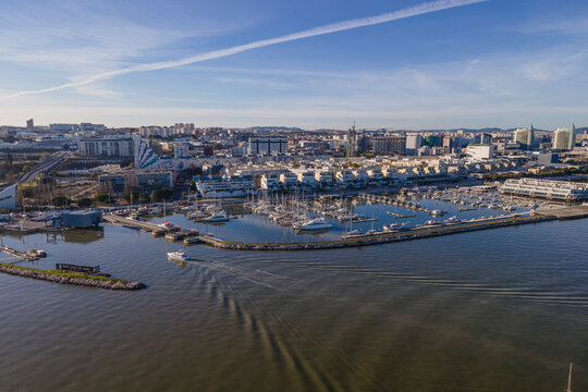 Aerial view of Lisbon city harbour and marina at sunset, Oriente, Lisbon, Portugal.