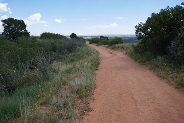 Hiking path of red rock gravel through scenic landscape