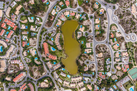 Aerial view of an exclusive luxury village with expensive villas and hotels on Troia Peninsula along the beach with artificial lake, Setubal, Portugal.