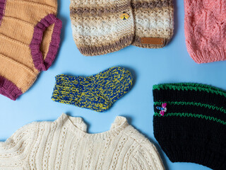 Knitted warm baby clothes. Multicolored socks, hats and gloves for girls and boys.