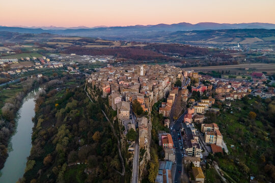 Aerial view of Orte, a small town on hilltop along the Tiber river at sunset, Viterbo, Italy.