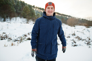 Fototapeta na wymiar Man running in winter nature. Outdoors in snow.