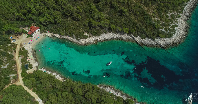 Aerial view of a few sailboats along the coast near the bay in Cara, Korcula, Croatia.