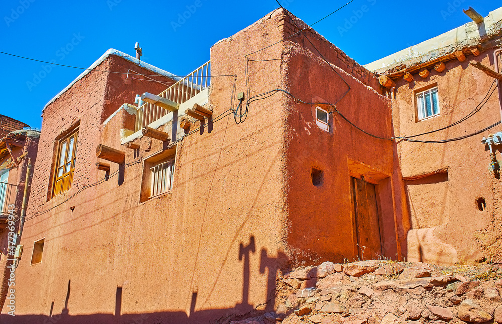 Canvas Prints Restored residential building with massive timber supports, covered with reddish mud, traditional for Abyaneh village, Iran.