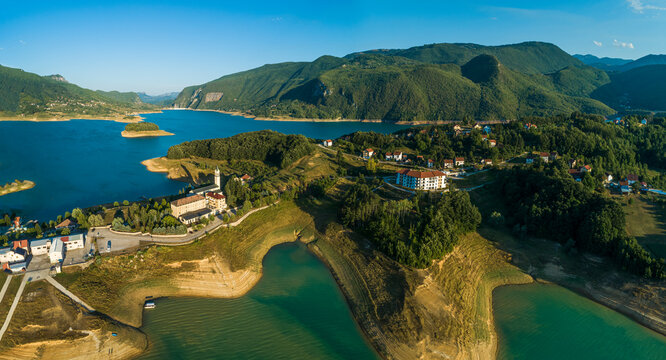Panoramic aerial view of small settlements along the coast of Rama Lake, Bosnia and Herzegovina.