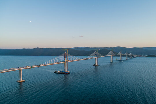Aerial view of Peljesac bridge, a suspended railroad and highway under construction crossing the Bay of Mali Ston in Croatia.