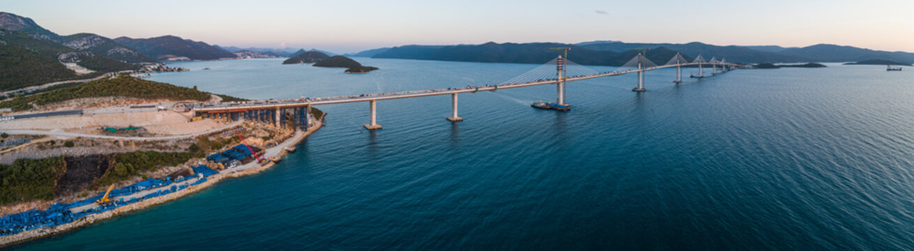 Aerial view of Peljesac bridge, a suspended railroad and highway under construction crossing the Bay of Mali Ston in Croatia.