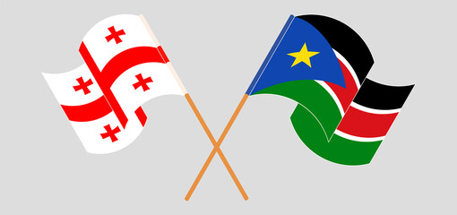 Crossed and waving flags of Georgia and South Sudan