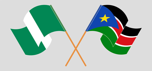 Crossed and waving flags of Nigeria and South Sudan