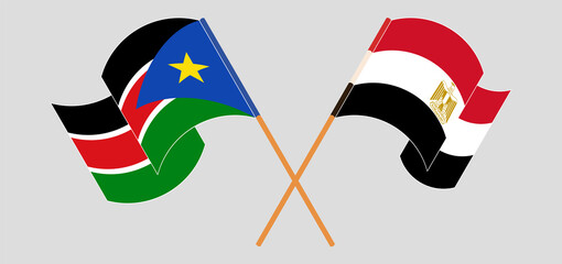 Crossed and waving flags of South Sudan and Egypt