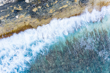 Aerial view of breaking waves, forming an abstract pattern, Maldives.